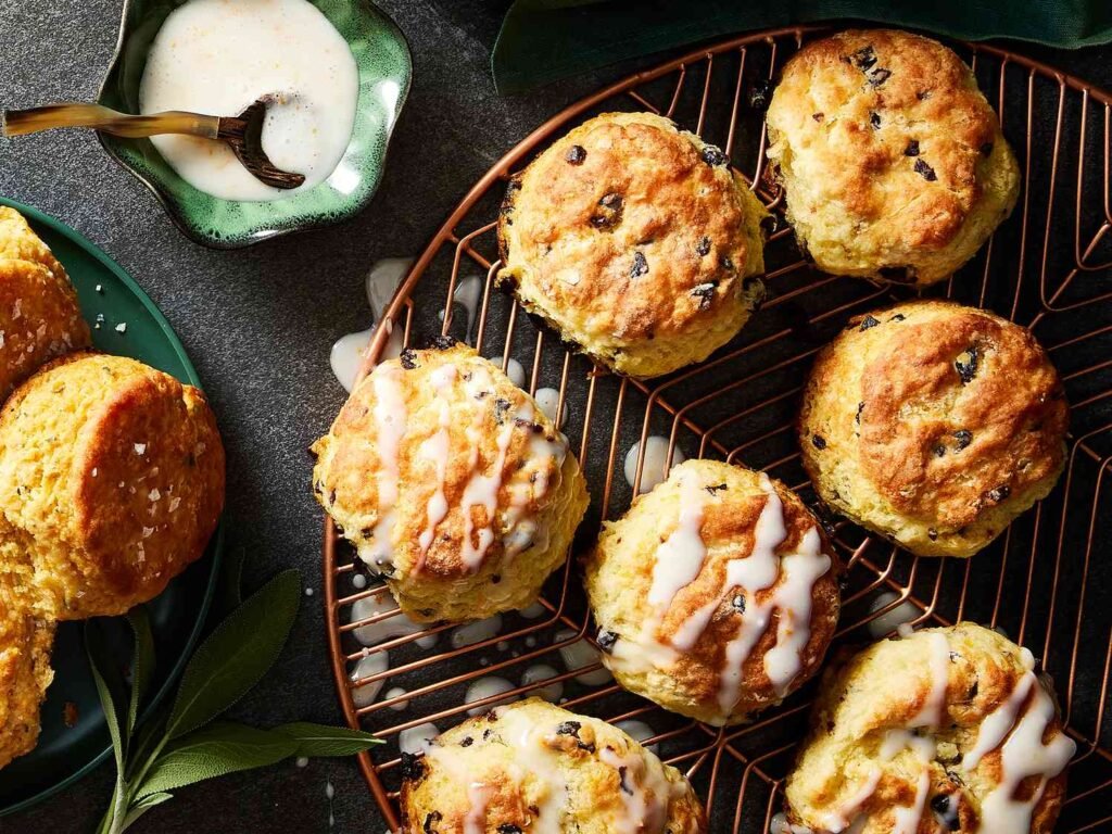 “Golden iced biscuits studded with dried cherries and drizzled with white icing.”