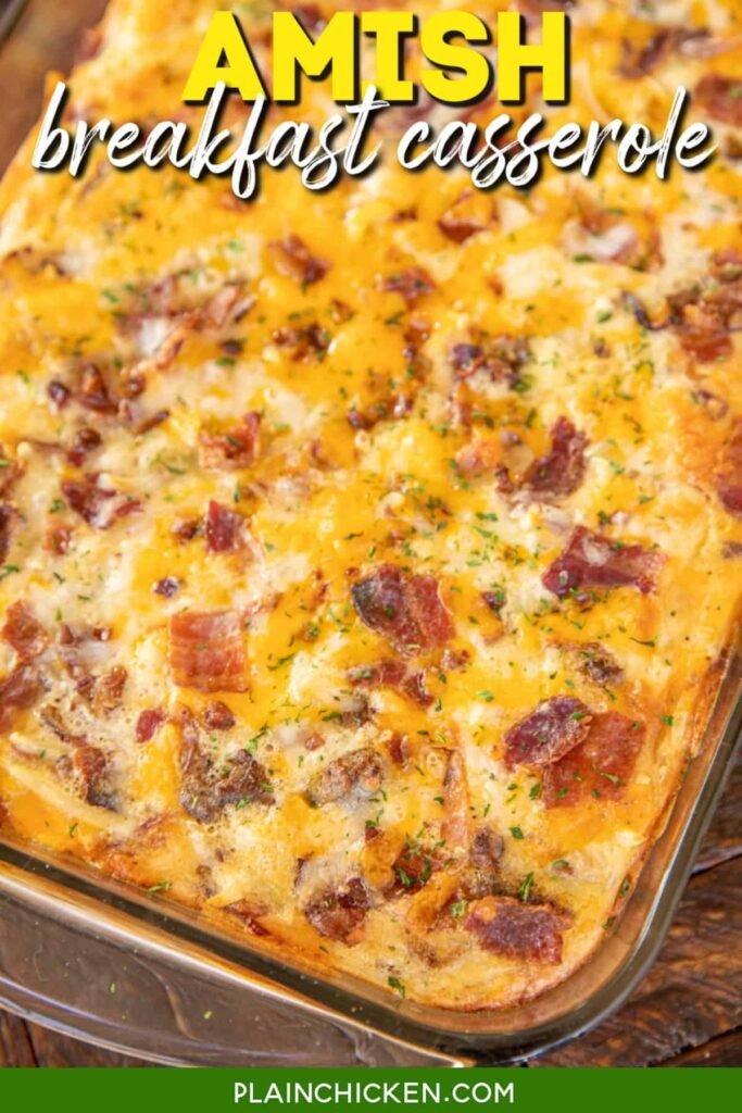 Cheesy Amish breakfast casserole in a white baking dish with golden crust and herbs on top