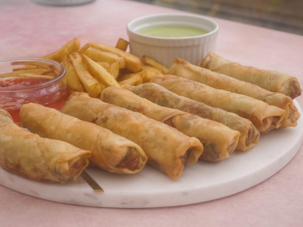 Freshly baked golden brown rolls arranged in a tray straight from the oven
