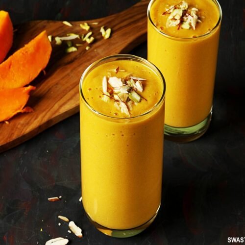 "Close-up of fresh mango cubes in a bowl, ready to be added to the blender."