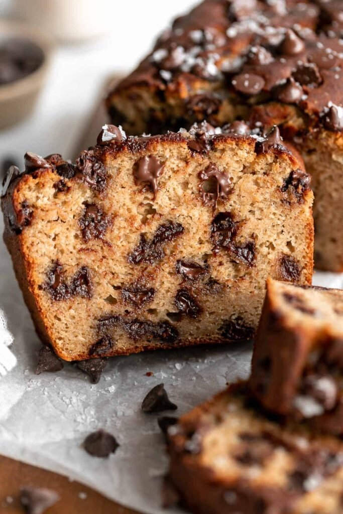 “Slice of high‑protein banana bread with chocolate chips, showing moist, speckled crumb.”