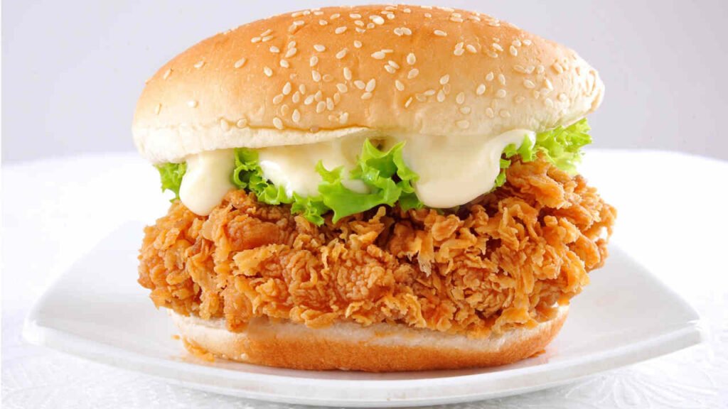 A classic crispy chicken fillet nestled in a soft sesame bun, topped with fresh lettuce and creamy sauce