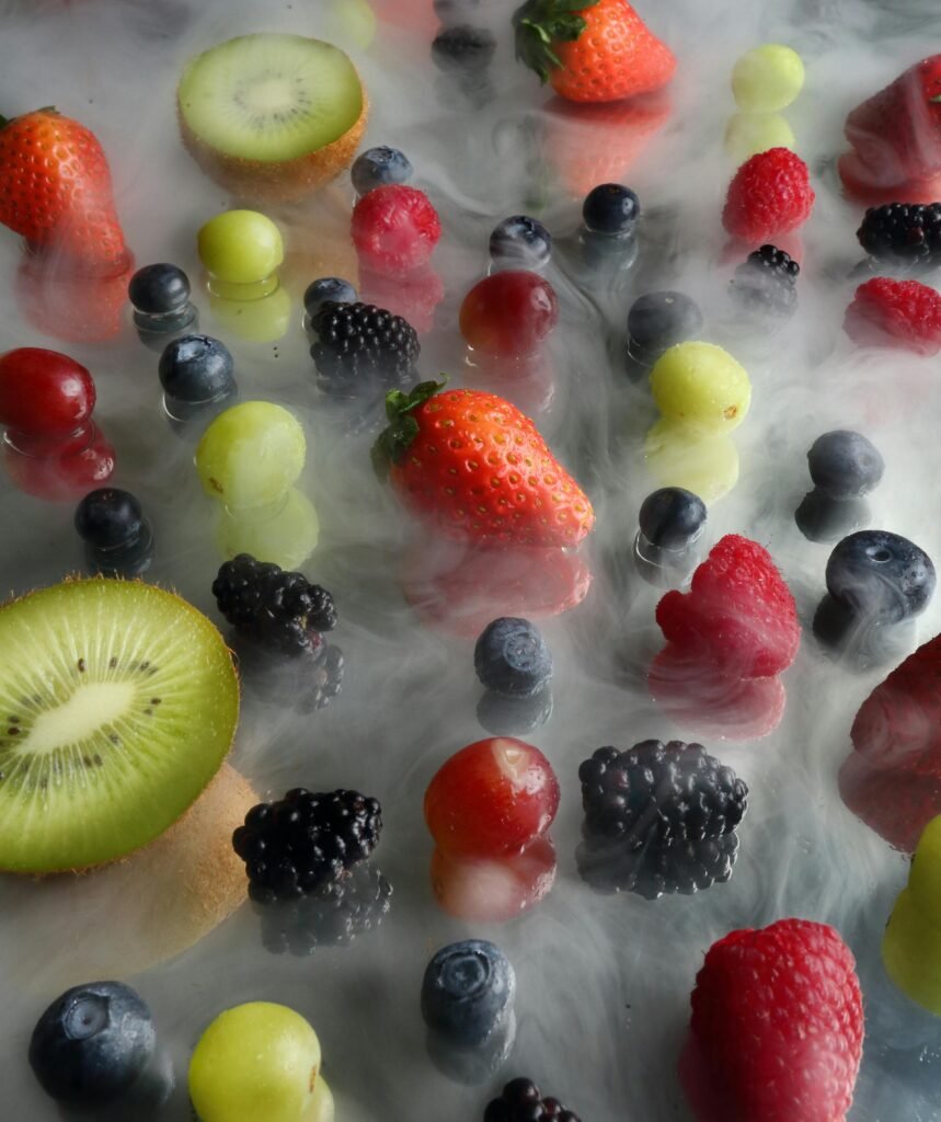 “Three summer berry recipes: strawberry yogurt parfait, blueberry lemonade, and raspberry chia pudding on a white table with natural lighting.”